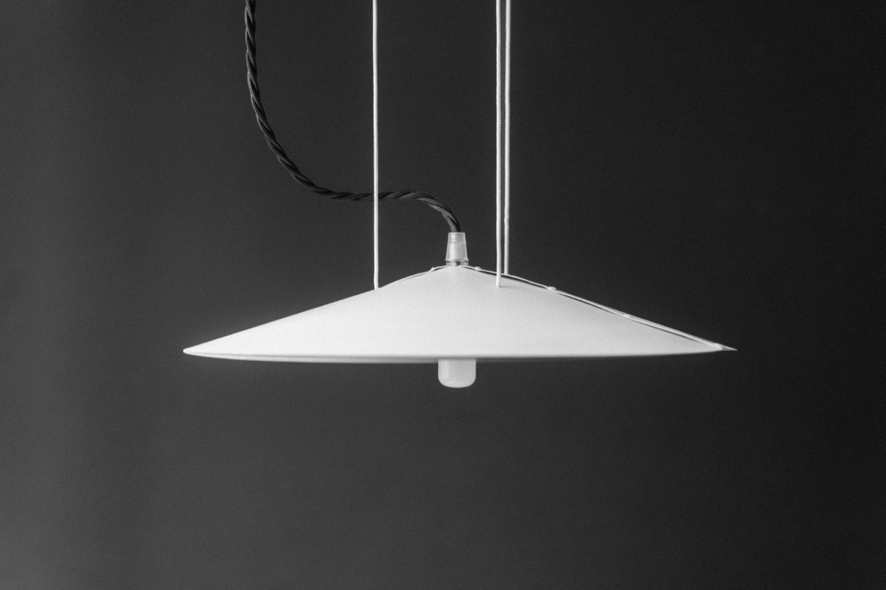 1895 Lamp by Tom Pradella — wide white pendant shade on cords against a dark wall