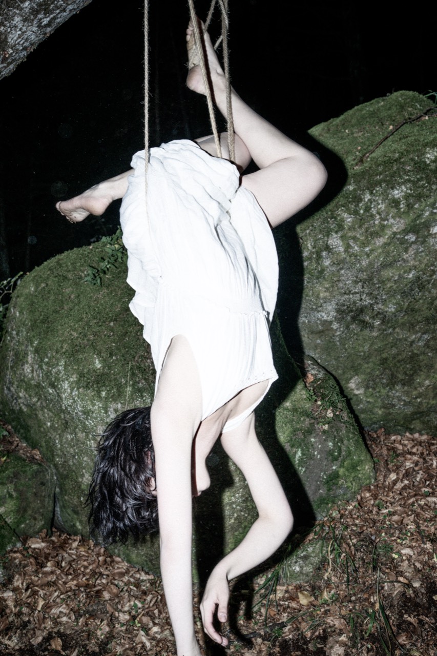 Tied — inverted rope suspension in a white dress