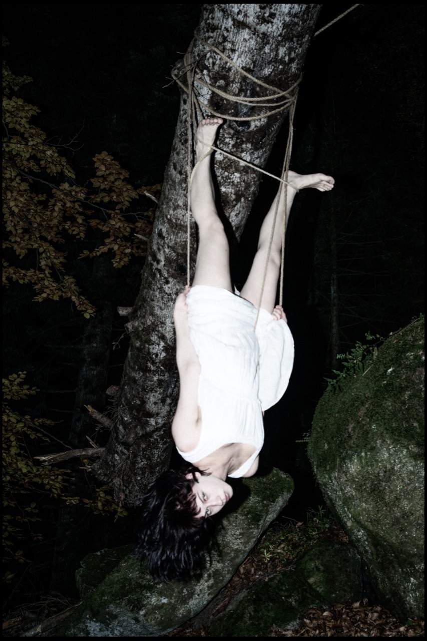 Tied — Anfisa hanging inverted along the rock face