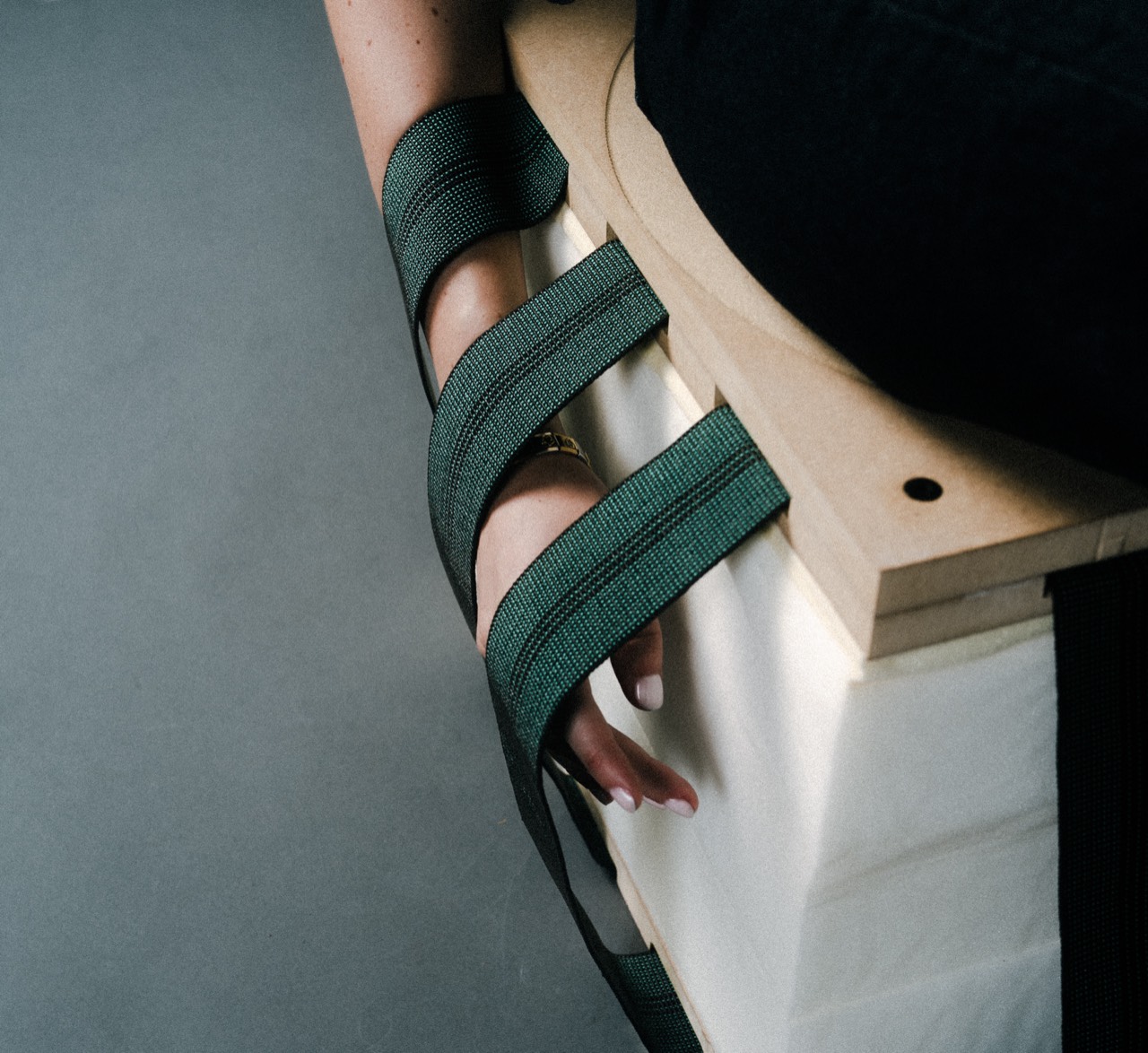 Inverso stool — upholstery straps wrapping the raw foam body