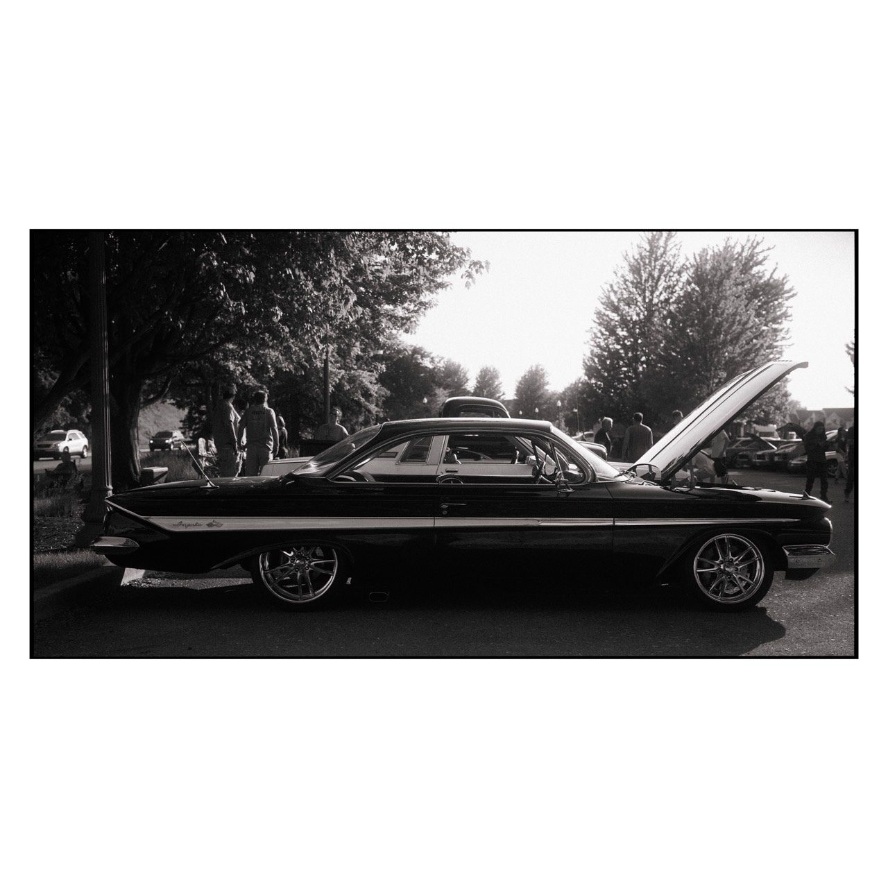 Lake Erie — classic car with its hood open under trees, black-and-white; photograph by Tom Pradella